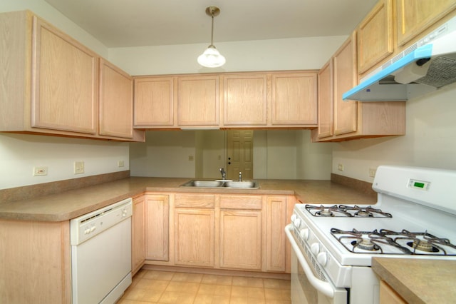 kitchen featuring white appliances, under cabinet range hood, light brown cabinetry, a sink, and hanging light fixtures