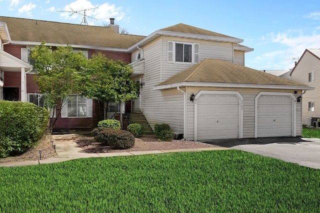 2485 Brunswick Cir Unit B2, Woodridge, IL 60517 - view of front of property with driveway, a front lawn, central air condition unit, and a garage