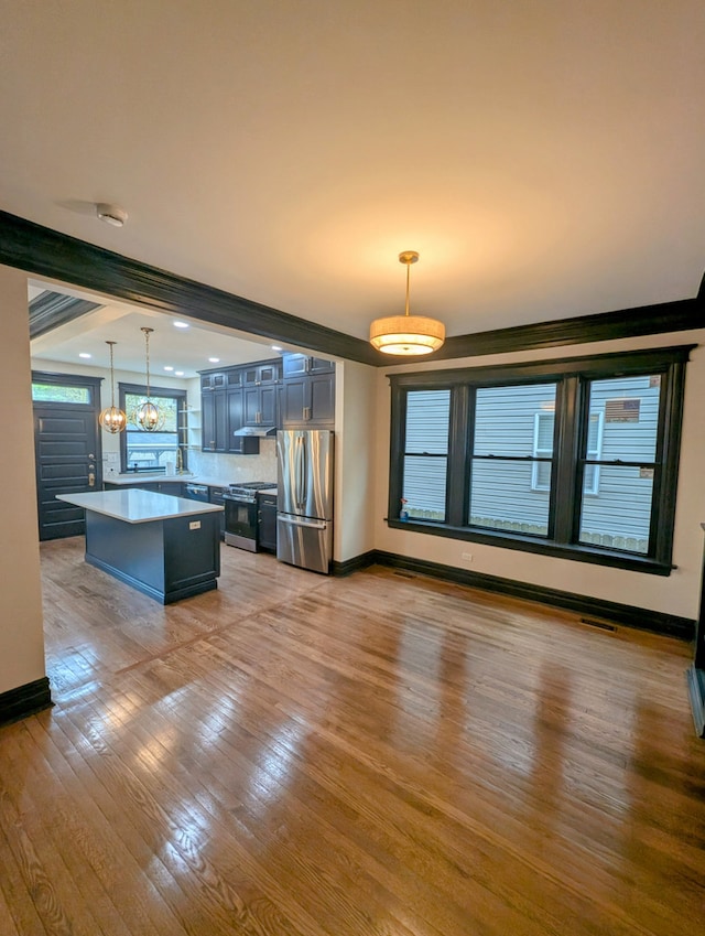 7411 S Champlain Ave, Chicago, IL 60619 - unfurnished living room featuring light wood-style flooring, baseboards, and beamed ceiling