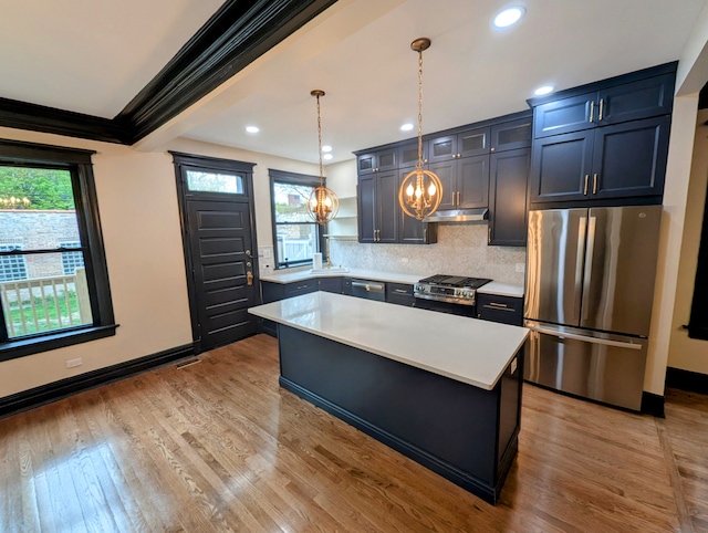 7411 S Champlain Ave, Chicago, IL 60619 - kitchen featuring stainless steel appliances, a chandelier, under cabinet range hood, light countertops, and crown molding