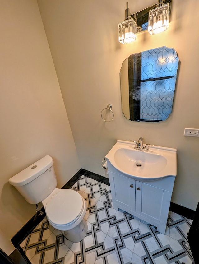 7411 S Champlain Ave, Chicago, IL 60619 - bathroom with toilet, baseboards, and vanity