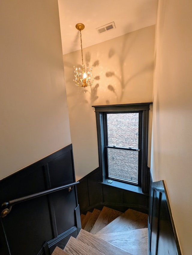 7411 S Champlain Ave, Chicago, IL 60619 - stairway featuring a chandelier and a wainscoted wall