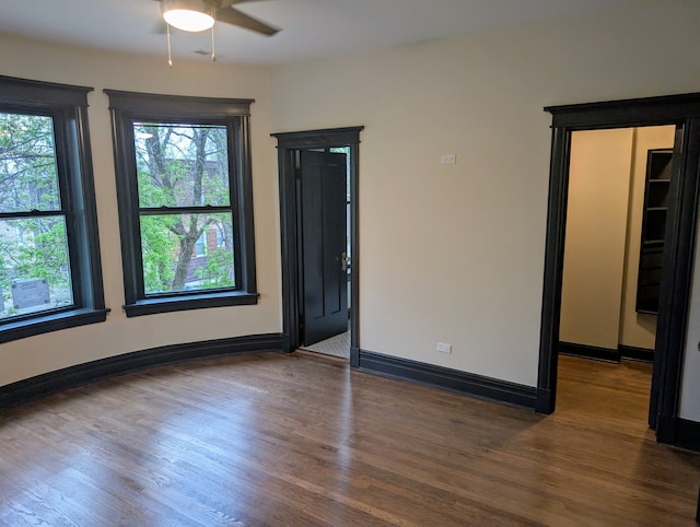 7411 S Champlain Ave, Chicago, IL 60619 - empty room featuring a ceiling fan, wood finished floors, and baseboards