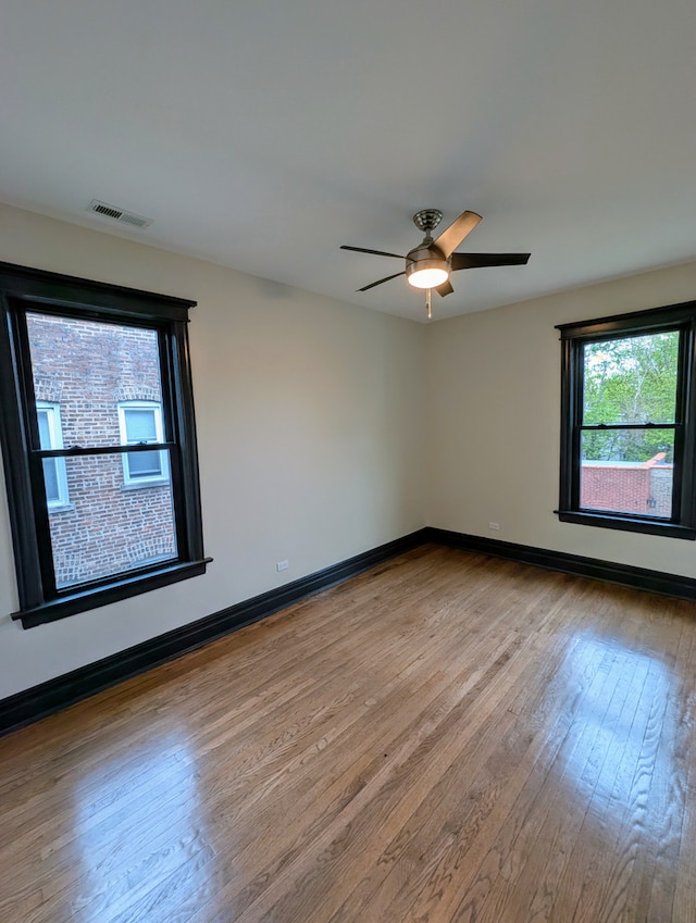 7411 S Champlain Ave, Chicago, IL 60619 - empty room featuring hardwood / wood-style floors, baseboards, and ceiling fan