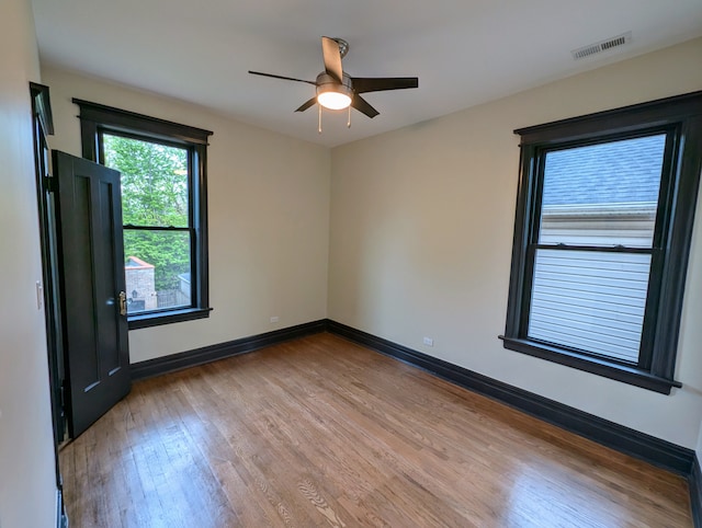 7411 S Champlain Ave, Chicago, IL 60619 - unfurnished room with wood finished floors, ceiling fan, and baseboards