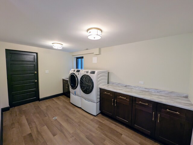 7411 S Champlain Ave, Chicago, IL 60619 - washroom with washing machine and dryer, cabinet space, light wood finished floors, and baseboards