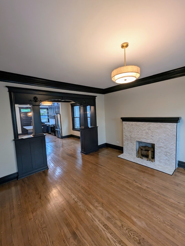 7411 S Champlain Ave, Chicago, IL 60619 - unfurnished living room featuring crown molding, baseboards, wood finished floors, and a fireplace
