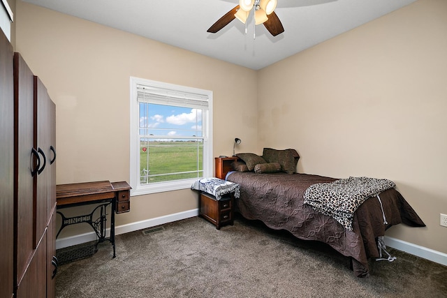 carpeted bedroom featuring baseboards and ceiling fan