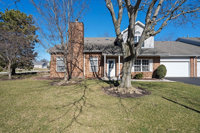 view of front of property featuring brick siding, a garage, and a front lawn