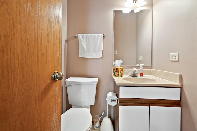 half bathroom with toilet and vanity