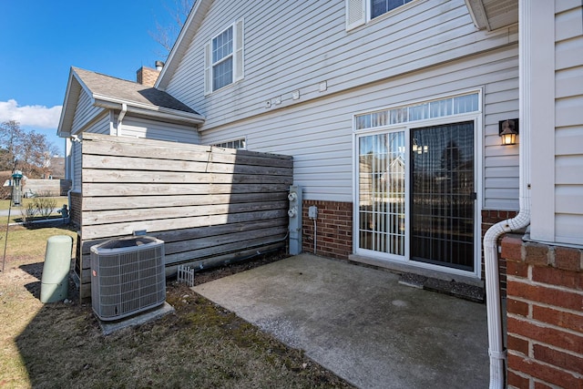 view of patio / terrace with central air condition unit and fence