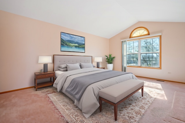 bedroom with light carpet, vaulted ceiling, and baseboards