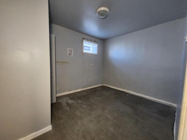 unfurnished room featuring baseboards