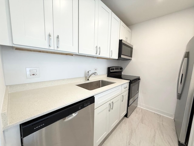 6 Villa Verde Dr Unit 102, Buffalo Grove, IL 60089 - kitchen featuring stainless steel appliances, white cabinetry, light marble finish flooring, and light stone countertops