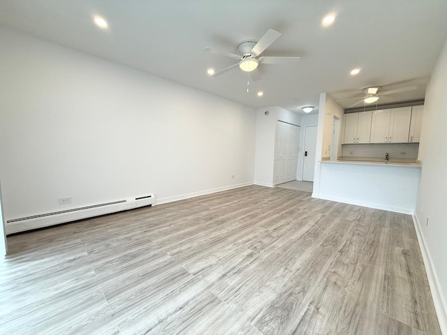 6 Villa Verde Dr Unit 102, Buffalo Grove, IL 60089 - unfurnished living room featuring baseboard heating, ceiling fan, recessed lighting, and light wood-style floors