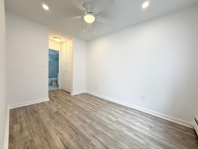 6 Villa Verde Dr Unit 102, Buffalo Grove, IL 60089 - spare room featuring wood finished floors, ceiling fan, recessed lighting, and a baseboard heating unit
