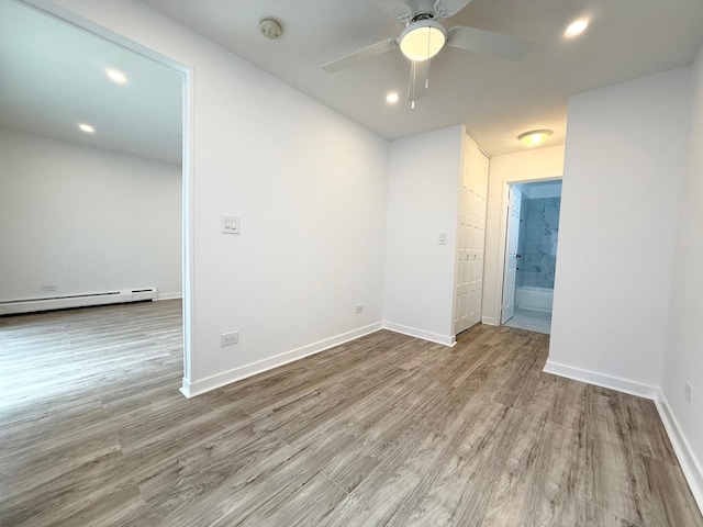 6 Villa Verde Dr Unit 102, Buffalo Grove, IL 60089 - empty room featuring wood finished floors, a ceiling fan, a baseboard heating unit, recessed lighting, and a smoke detector