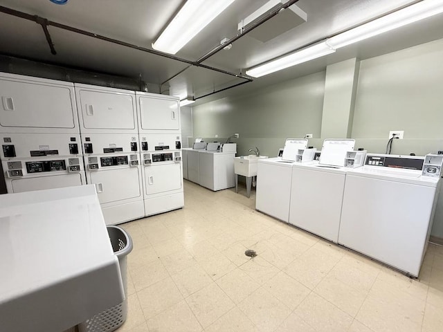 6 Villa Verde Dr Unit 102, Buffalo Grove, IL 60089 - shared laundry with estacked washer and dryer, washer and clothes dryer, and light flooring