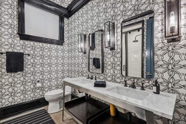 1855 N Hermitage Ave, Chicago, IL 60622 - bathroom with wallpapered walls, toilet, and dual sinks