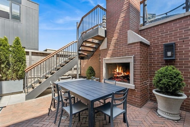 1855 N Hermitage Ave, Chicago, IL 60622 - view of patio / terrace featuring stairs, outdoor dining area, and an outdoor brick fireplace