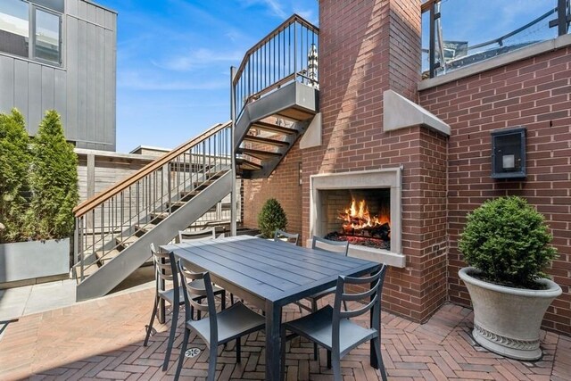 1855 N Hermitage Ave, Chicago, IL 60622 - view of patio / terrace featuring stairs, outdoor dining area, and an outdoor brick fireplace
