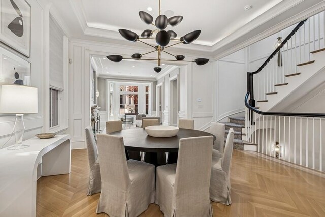 1855 N Hermitage Ave, Chicago, IL 60622 - dining area with a decorative wall, a chandelier, stairs, and ornamental molding