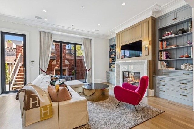 1855 N Hermitage Ave, Chicago, IL 60622 - living room featuring a premium fireplace, ornamental molding, light wood-style floors, recessed lighting, and baseboards