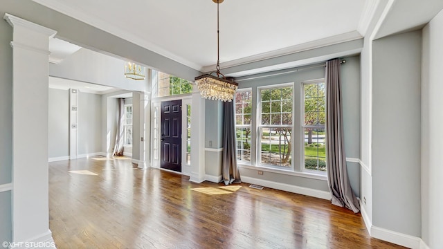 8 Georgetown Ct, Algonquin, IL 60102 - unfurnished dining area with a chandelier, plenty of natural light, ornamental molding, wood finished floors, and baseboards