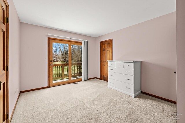 4302 Fox Creek Dr, Crystal Lake, IL 60012 - unfurnished bedroom with access to exterior, baseboards, and light colored carpet