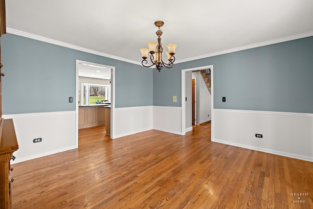 4302 Fox Creek Dr, Crystal Lake, IL 60012 - unfurnished room featuring a chandelier, ornamental molding, wood finished floors, baseboards, and stairs