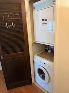 75 6th Ave Unit 209, La Grange, IL 60525 - laundry area with stacked washer / drying machine and light wood-style floors