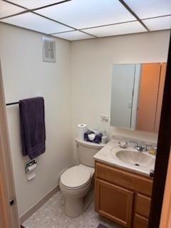 75 6th Ave Unit 209, La Grange, IL 60525 - bathroom with a paneled ceiling, toilet, vanity, and baseboards
