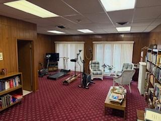 75 6th Ave Unit 209, La Grange, IL 60525 - exercise room featuring carpet floors, wooden walls, and a drop ceiling