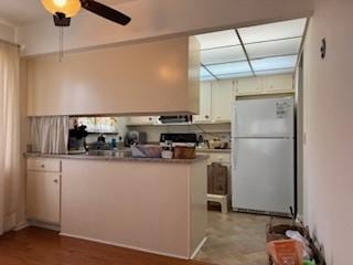 75 6th Ave Unit 209, La Grange, IL 60525 - kitchen with freestanding refrigerator, ceiling fan, a peninsula, and white cabinetry