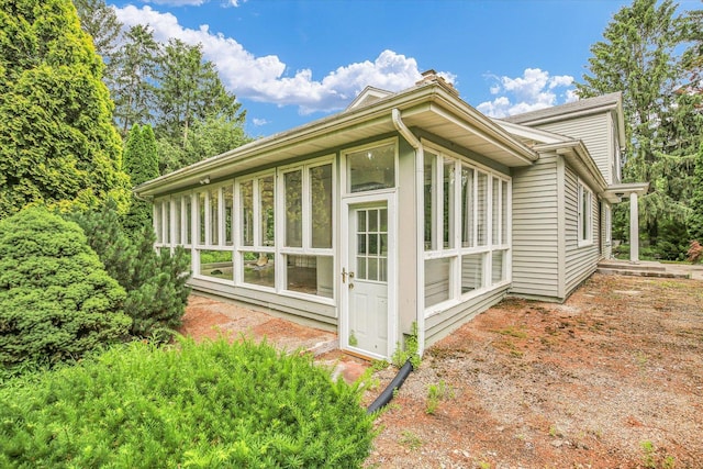 2109 Grange Dr, Urbana, IL 61801 - view of side of property featuring a sunroom and a chimney