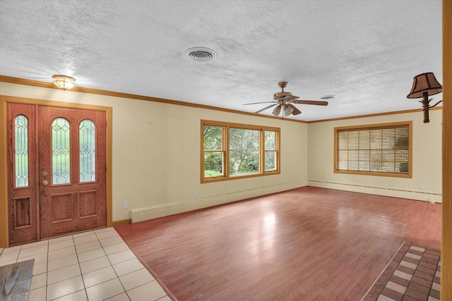 2109 Grange Dr, Urbana, IL 61801 - foyer featuring wood finished floors, a baseboard radiator, a ceiling fan, ornamental molding, and a textured ceiling