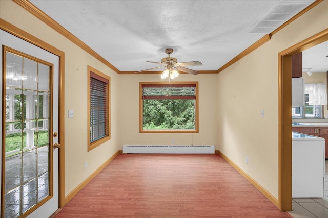 2109 Grange Dr, Urbana, IL 61801 - spare room featuring baseboard heating, healthy amount of natural light, light wood-style flooring, a ceiling fan, and crown molding