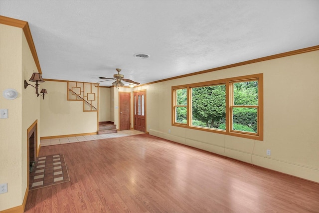 2109 Grange Dr, Urbana, IL 61801 - unfurnished living room featuring wood finished floors, stairs, crown molding, and ceiling fan