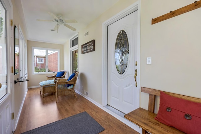 entrance foyer featuring wood finished floors, ceiling fan, and baseboards