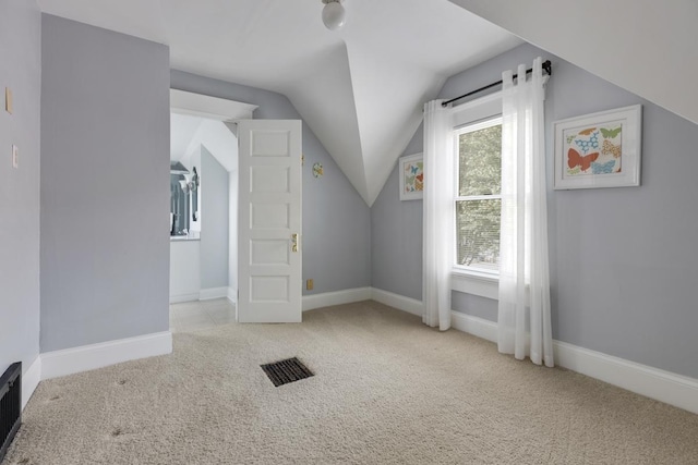 bonus room featuring carpet floors, vaulted ceiling, and baseboards