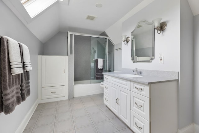 full bath featuring lofted ceiling, vanity, a skylight, and combined bath / shower with glass door