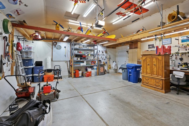 garage with a workshop area and a garage door opener