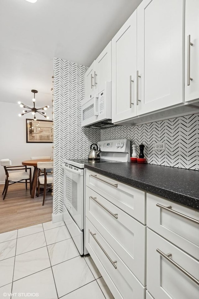 6171 N Sheridan Rd Unit 2704, Chicago, IL 60660 - kitchen with white appliances, white cabinets, baseboards, and decorative backsplash