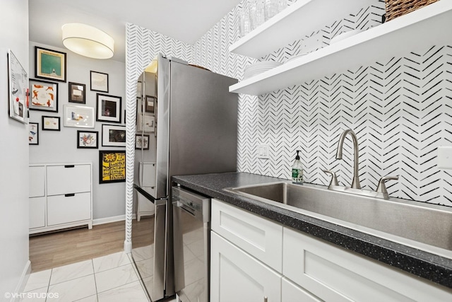6171 N Sheridan Rd Unit 2704, Chicago, IL 60660 - kitchen with dishwasher, baseboards, white cabinets, a sink, and dark countertops