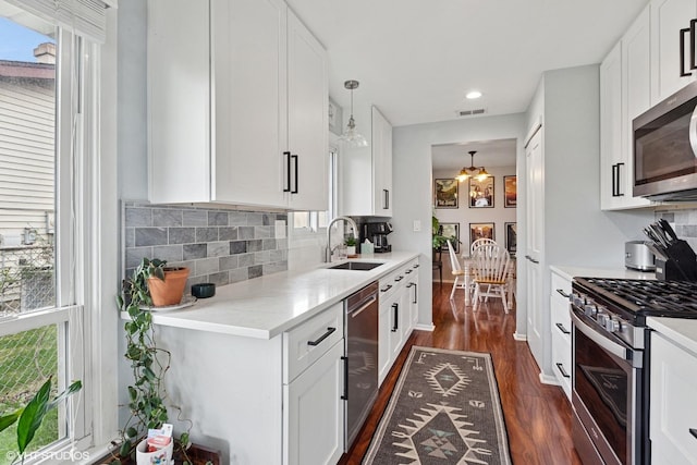 1313 S Elizabeth St, Lombard, IL 60148 - kitchen with appliances with stainless steel finishes, dark wood-style floors, a sink, backsplash, and recessed lighting