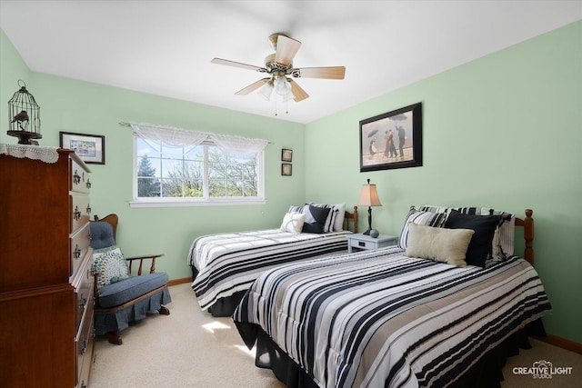 carpeted bedroom featuring baseboards and ceiling fan