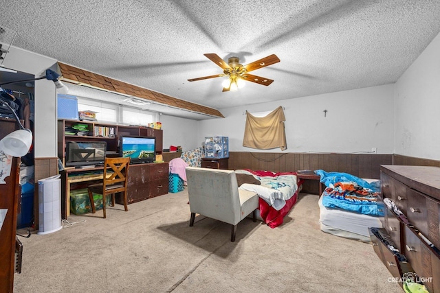 1020 Hahn Pl, West Chicago, IL 60185 - carpeted bedroom with wooden walls, ceiling fan, a textured ceiling, and a wainscoted wall