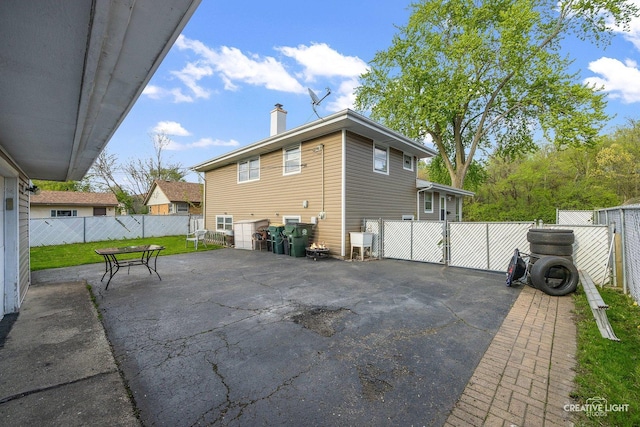 1020 Hahn Pl, West Chicago, IL 60185 - view of property exterior with a chimney, fence, and a patio area
