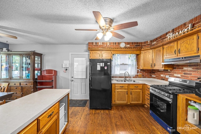 1020 Hahn Pl, West Chicago, IL 60185 - kitchen featuring freestanding refrigerator, stainless steel gas range oven, under cabinet range hood, ceiling fan, and a textured ceiling
