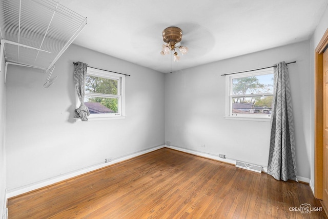 1020 Hahn Pl, West Chicago, IL 60185 - unfurnished room with wood finished floors, a ceiling fan, and baseboards